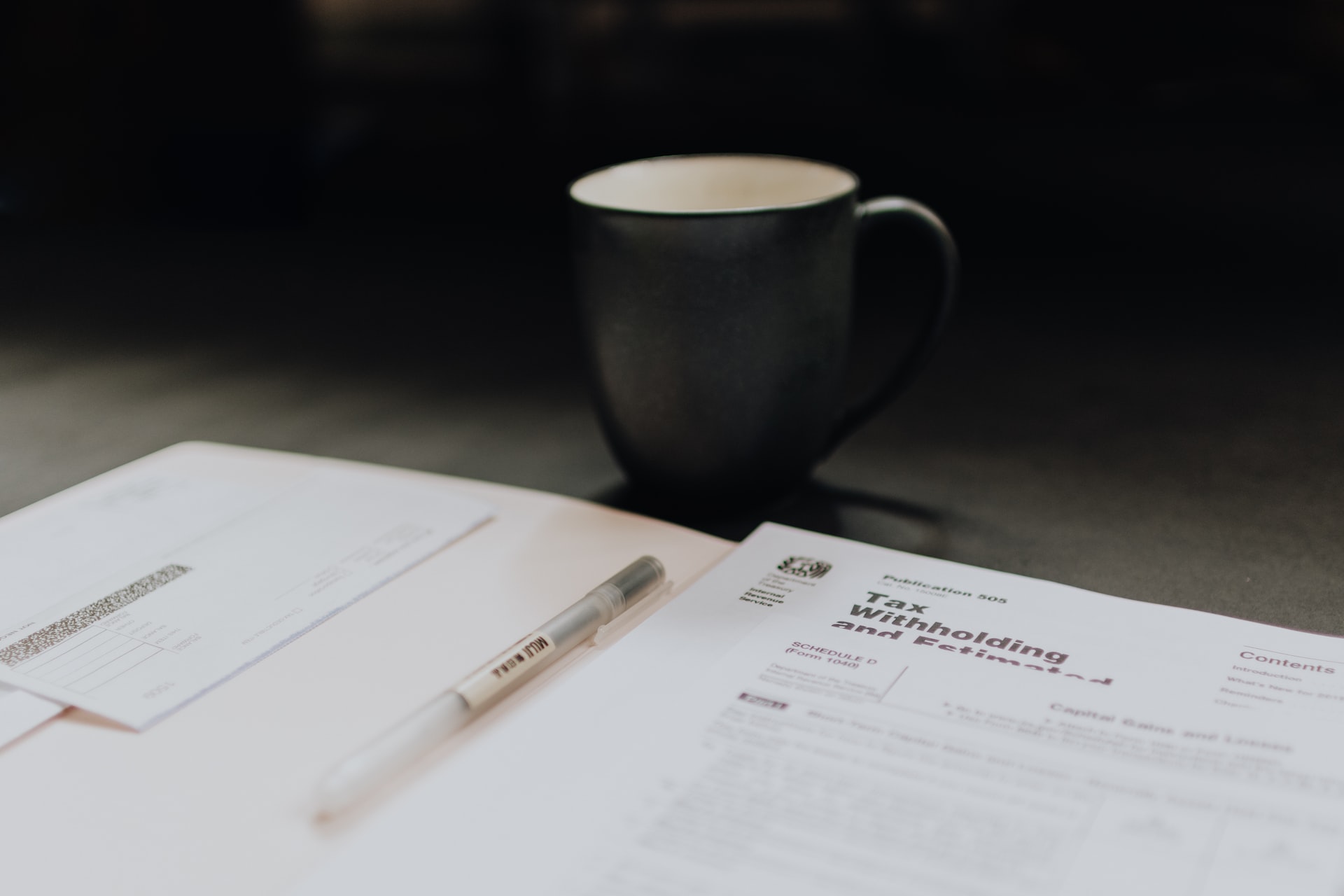 A coffee mug next to a double tax treaty form for a business's corporate tax